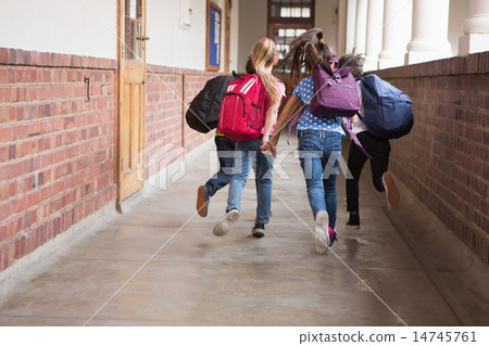 Cute pupils running down the hall Cute pupils running down the hall 14745761