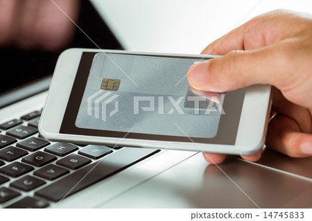 Man using laptop and phone for online shopping Man using laptop and phone for online shopping 14745833