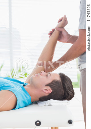 Doctor examining his patient arm 14745898