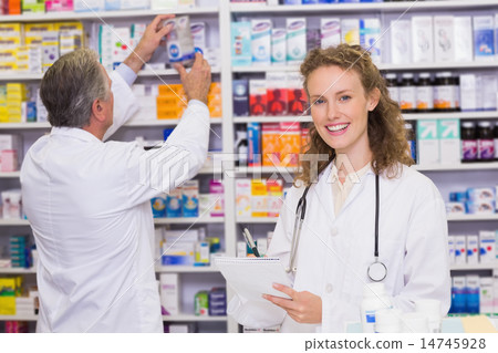 Pharmacists searching medicines with prescription Pharmacists searching medicines with prescription 14745928