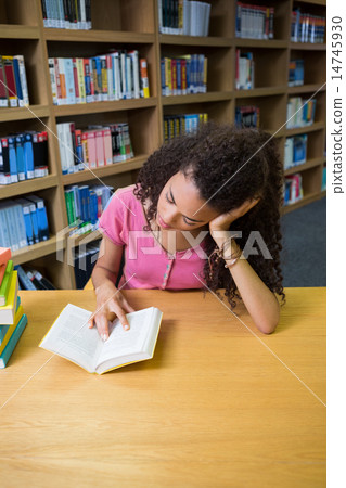 Pretty student studying in the library Pretty student studying in the library 14745930