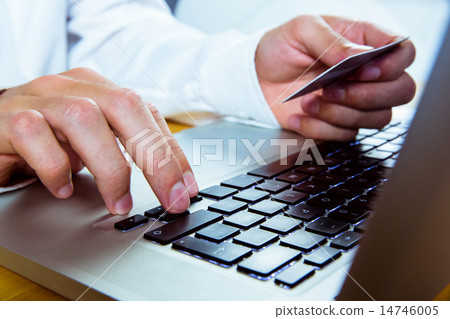 Man using laptop for online shopping 14746005