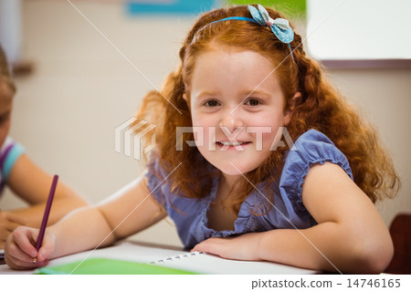 Pupil working hard at desk 14746165