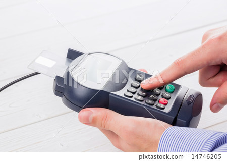 Man entering his pin on terminal 14746205