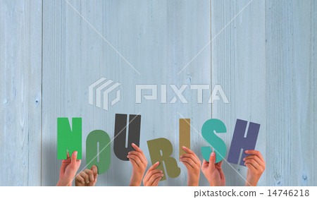 Composite image of hands holding up nourish 14746218