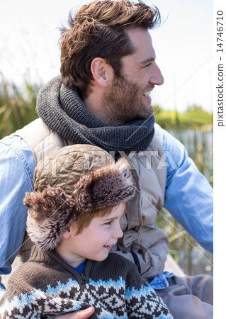 Happy casual father and son at a lake 14746710