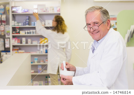 Senior pharmacist mixing a medicine Senior pharmacist mixing a medicine 14746814
