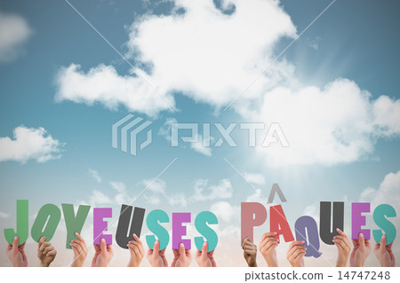 Composite image of hands holding up joyeuses pasques 14747248