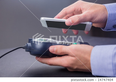 Man using smartphone to express pay Man using smartphone to express pay 14747404