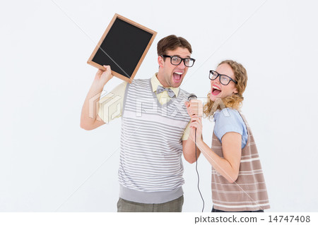 Geeky hipster couple singing into a microphone 14747408
