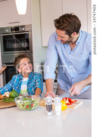 Happy family preparing vegetables together Happy family preparing vegetables together 14747409