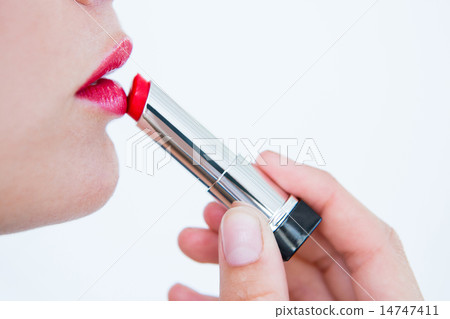 Woman putting red lipstick 14747411