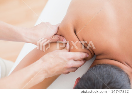 Physiotherapist doing shoulder massage to her patient Physiotherapist doing shoulder massage to her patient 14747822