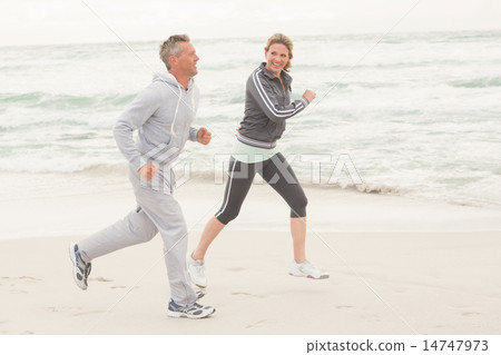 Fit couple jogging together Fit couple jogging together 14747973