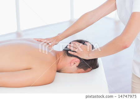Physiotherapist doing neck massage to her patient Physiotherapist doing neck massage to her patient 14747975