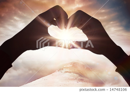 Composite image of woman making heart shape with hands Composite image of woman making heart shape with hands 14748106