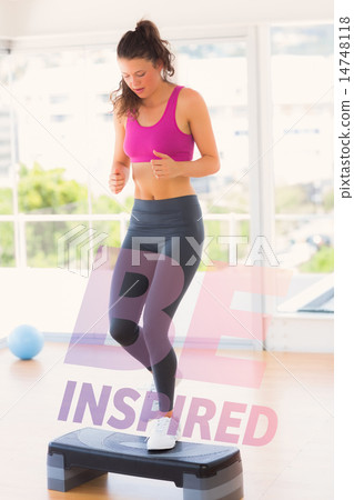 Composite image of full length of a fit woman performing step ae Composite image of full length of a fit woman performing step ae 14748118