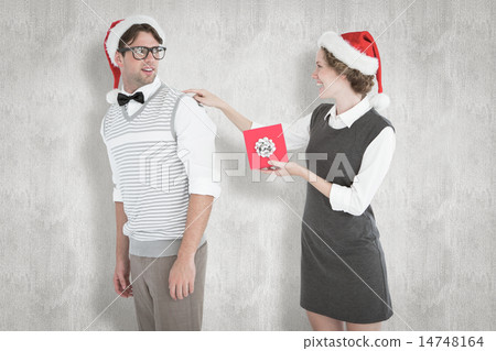 Composite image of geeky hipster offering present to her boyfrie Composite image of geeky hipster offering present to her boyfrie 14748164
