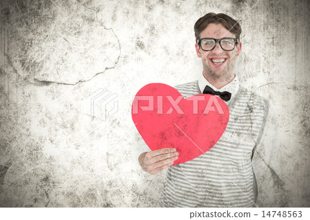 Composite image of geeky hipster holding heart card 14748563