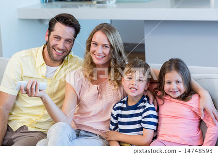 Happy family on the couch watching tv 14748593