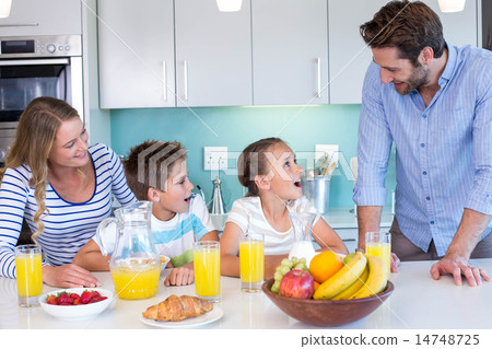 Happy family having breakfast together Happy family having breakfast together 14748725