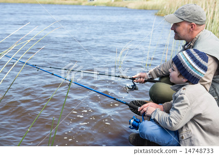 Father and son fishing at a lake Father and son fishing at a lake 14748733