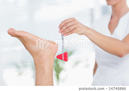 Physiotherapist using reflex hammer Physiotherapist using reflex hammer 14748866