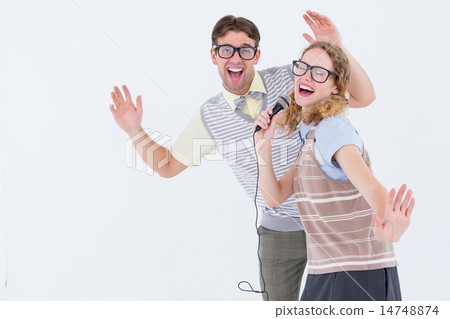 Geeky hipster couple singing into a microphone 14748874