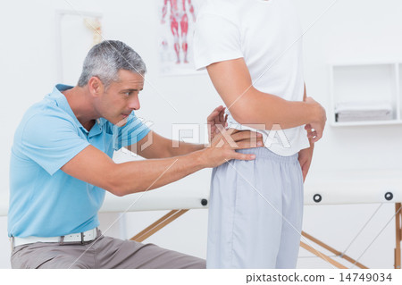 Doctor examining his patient back Doctor examining his patient back 14749034
