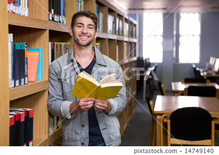 Student smiling at camera in library Student smiling at camera in library 14749140