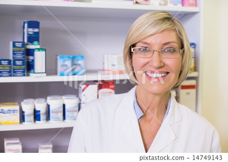Smiling pharmacist in lab coat looking at camera Smiling pharmacist in lab coat looking at camera 14749143