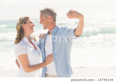 Happy couple taking a selfie Happy couple taking a selfie 14749144