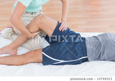 Man stretching with his trainer Man stretching with his trainer 14749321