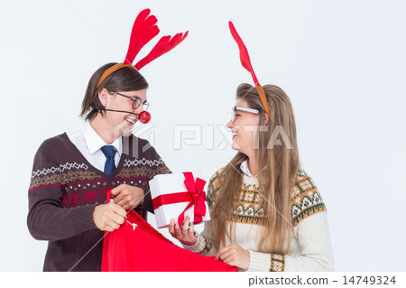 Happy geeky hipster couple holding present Happy geeky hipster couple holding present 14749324