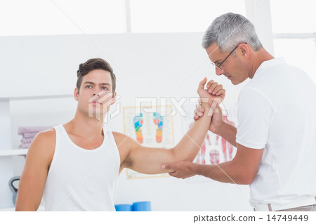 Doctor examining his patient arm 14749449