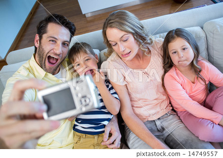 Happy family taking selfie on couch Happy family taking selfie on couch 14749557