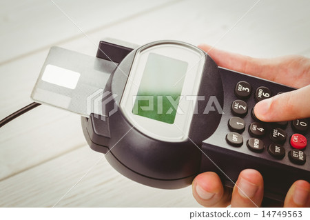 Man entering his pin on terminal Man entering his pin on terminal 14749563