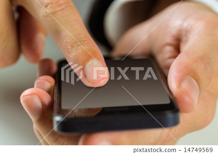 Businessman using his smart phone Businessman using his smart phone 14749569