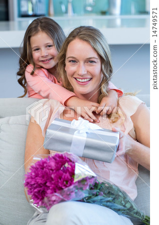 Daughter surprising mother with gift 14749571