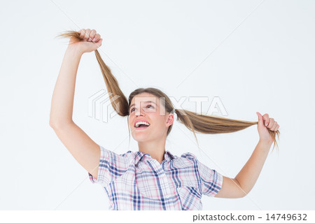 Geeky hipster holding her pigtails Geeky hipster holding her pigtails 14749632