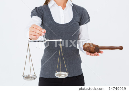 Woman holding a gavel and scales of justice 14749919