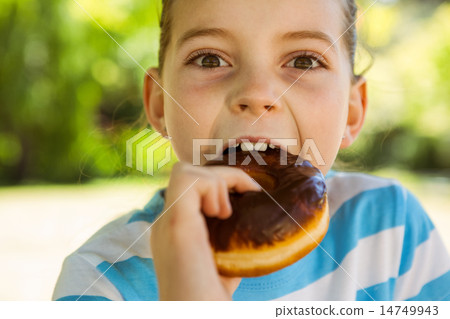 Cute little girl eating doughnut 14749943