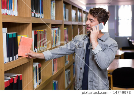 Student talking on the phone in library Student talking on the phone in library 14749978