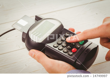 Man entering his pin on terminal Man entering his pin on terminal 14749997