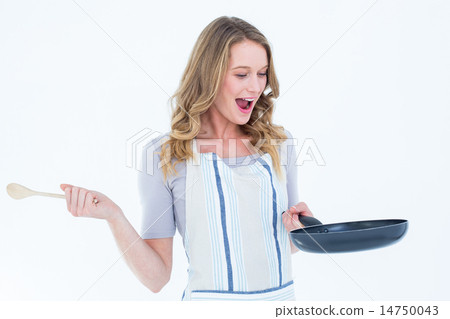 Smiling woman holding frying pan and wooden spoon 14750043