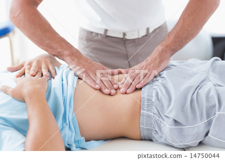 Doctor examining his patient stomach Doctor examining his patient stomach 14750044
