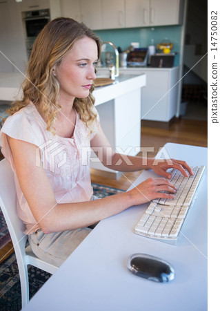 Pretty blonde using computer Pretty blonde using computer 14750082