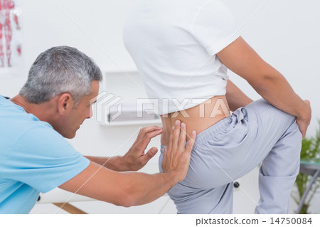 Doctor examining his patient back Doctor examining his patient back 14750084