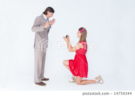 Pretty hipster on bended knee doing a marriage proposal to her b Pretty hipster on bended knee doing a marriage proposal to her b 14750344