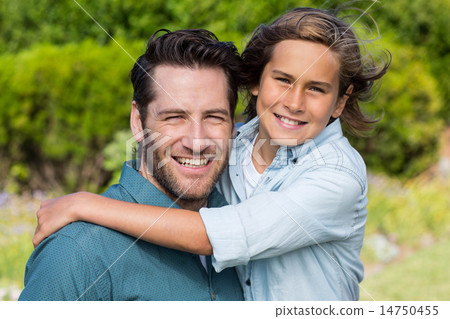 Father and son smiling at camera 14750455